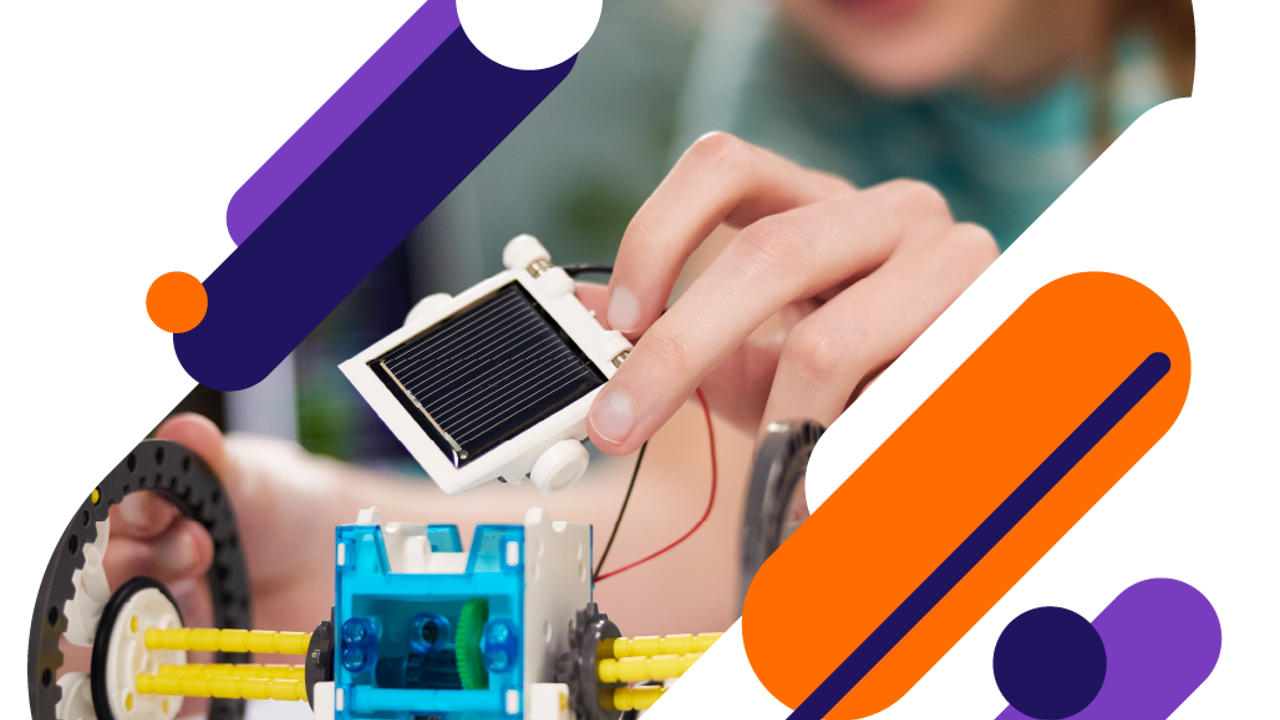 Close up of a young person working on a small model engine. They are holding what looks like a mini solar panel. 