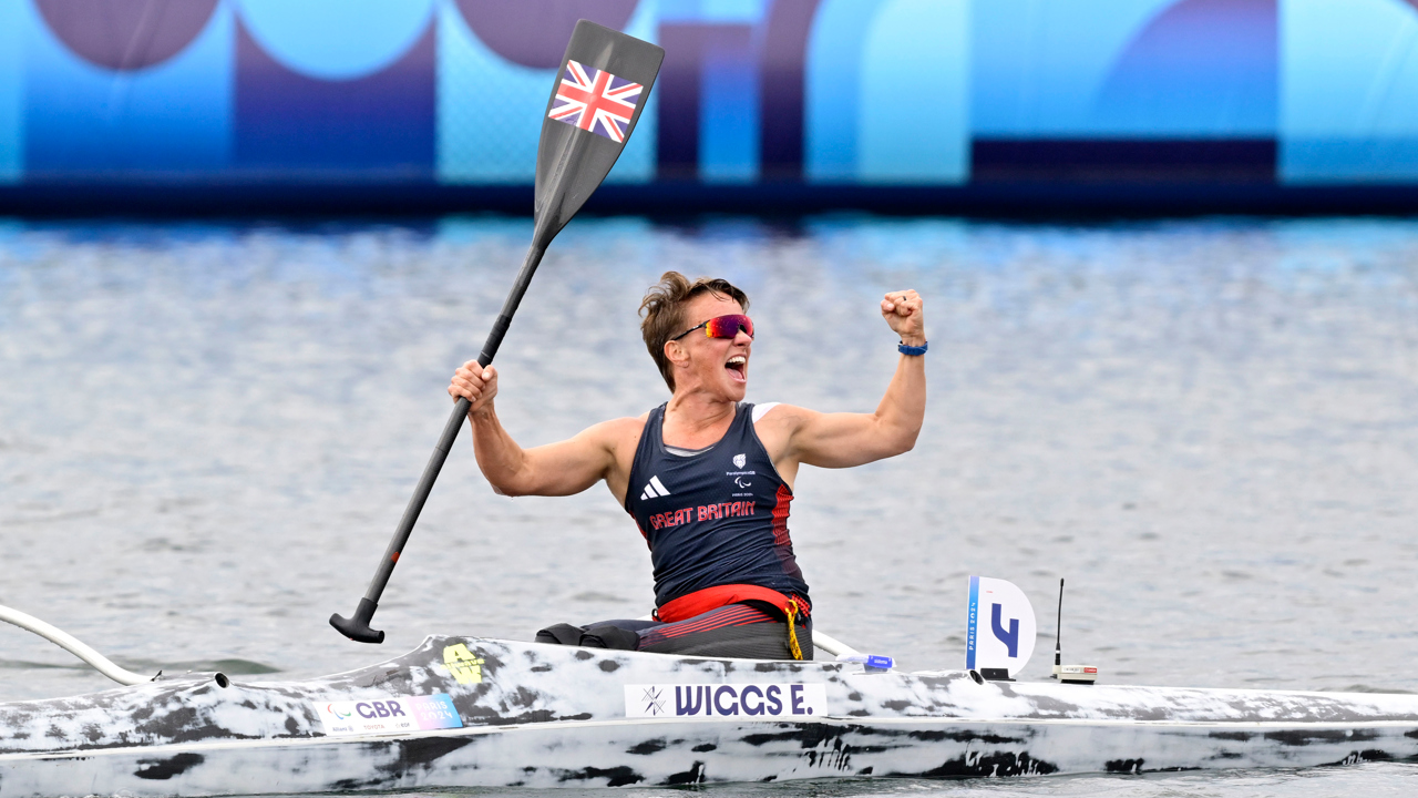 Emma Wiggs at the Paralympics celebrating in a canoe