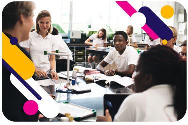 An image of a group of young people during a science lesson at school. They are around the science work bench as a teacher talks. 