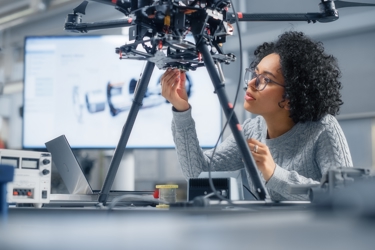 Close up of someone working with complicated apparatus or machinery