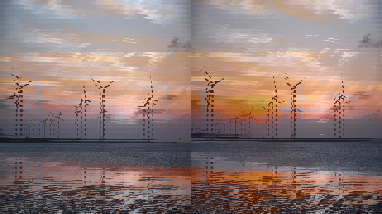 Wind turbines in water at sunset